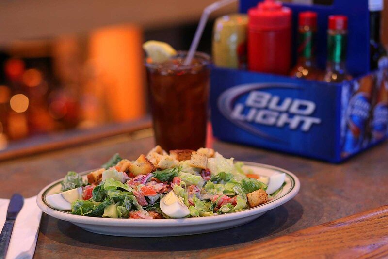 Salad with eggs and glass of soda