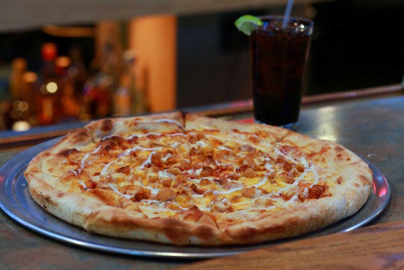 Pizza pie with glass of soda